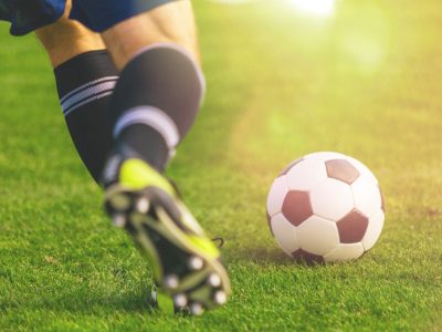 Running soccer player on grass